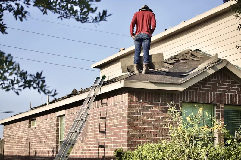 Professional roofer working on a residential roof in Northmoor Estates